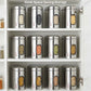  Ebun Stainless steel storage jars visible on a kitchen shelf.