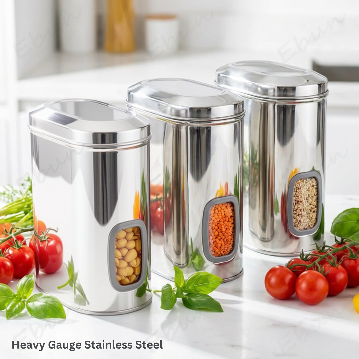 Three Ebun stainless steel storage containers with food on a kitchen counter